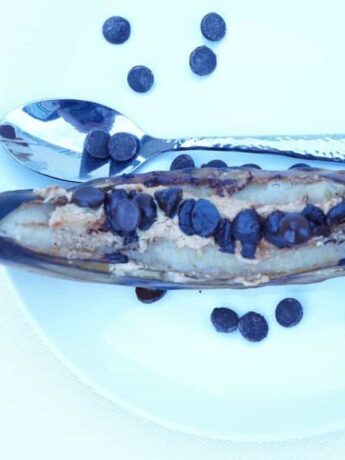 A paleo dessert worthy of every summer BBQ and cookout. Grilled bananas with peanut butter and chocolate morsels make a delicious, healthy and balanced dessert