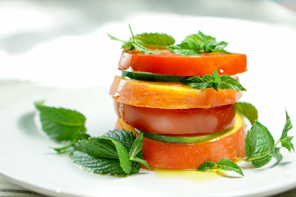 Peach Tomato Mint Salad Stack Recipe - Simply slice fresh peaches, tomatoes and cucumbers, stacking with mint to create this great appetizer, light meal or side salad. This will definitely be a recipe to impress your friends at your next barbq or family dinner!