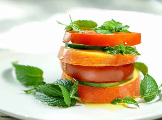 Peach Tomato Mint Salad Stack Recipe - Simply slice fresh peaches, tomatoes and cucumbers, stacking with mint to create this great appetizer, light meal or side salad. This will definitely be a recipe to impress your friends at your next barbq or family dinner!