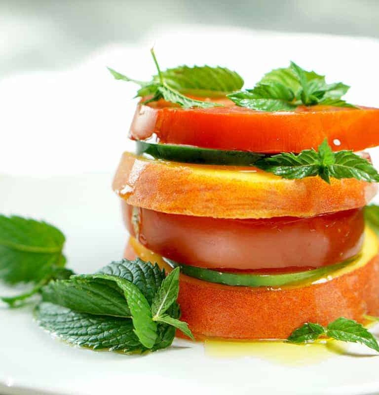 Peach Tomato Mint Salad Stack Recipe - Simply slice fresh peaches, tomatoes and cucumbers, stacking with mint to create this great appetizer, light meal or side salad. This will definitely be a recipe to impress your friends at your next barbq or family dinner!