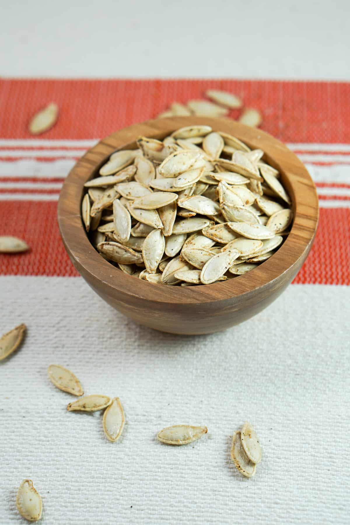 This toasted salted pumpkin seeds recipe is ridiculously easy. Wash & strain, season, dry and roast for deliciously crisp seeds. Then crunch away and enjoy!