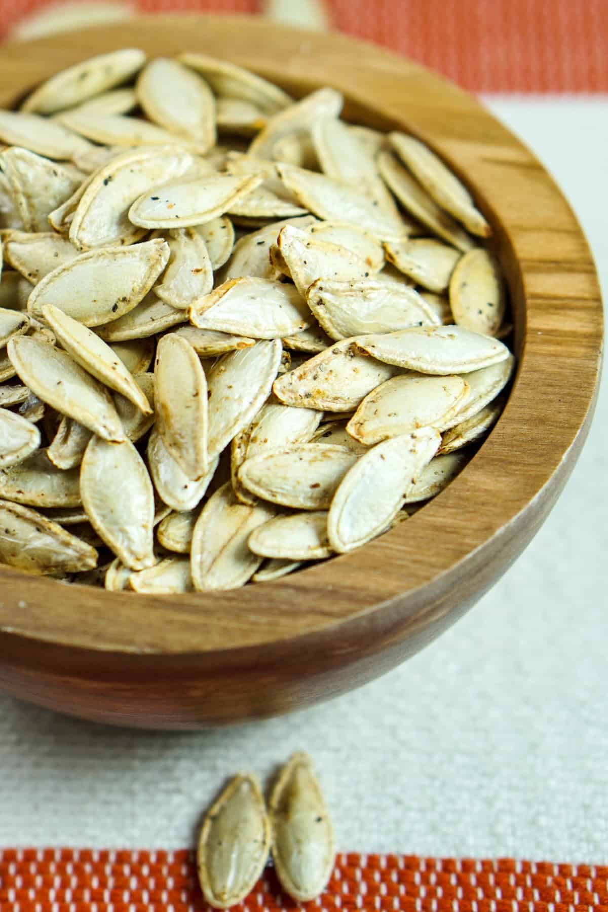 This toasted salted pumpkin seeds recipe is ridiculously easy. Wash & strain, season, dry and roast for deliciously crisp seeds. Then crunch away and enjoy!