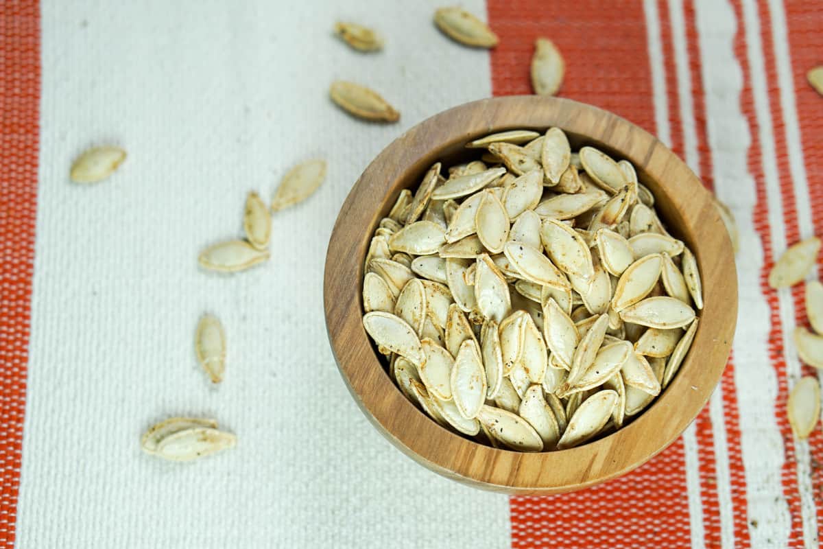 This toasted salted pumpkin seeds recipe is ridiculously easy. Wash & strain, season, dry and roast for deliciously crisp seeds. Then crunch away and enjoy!