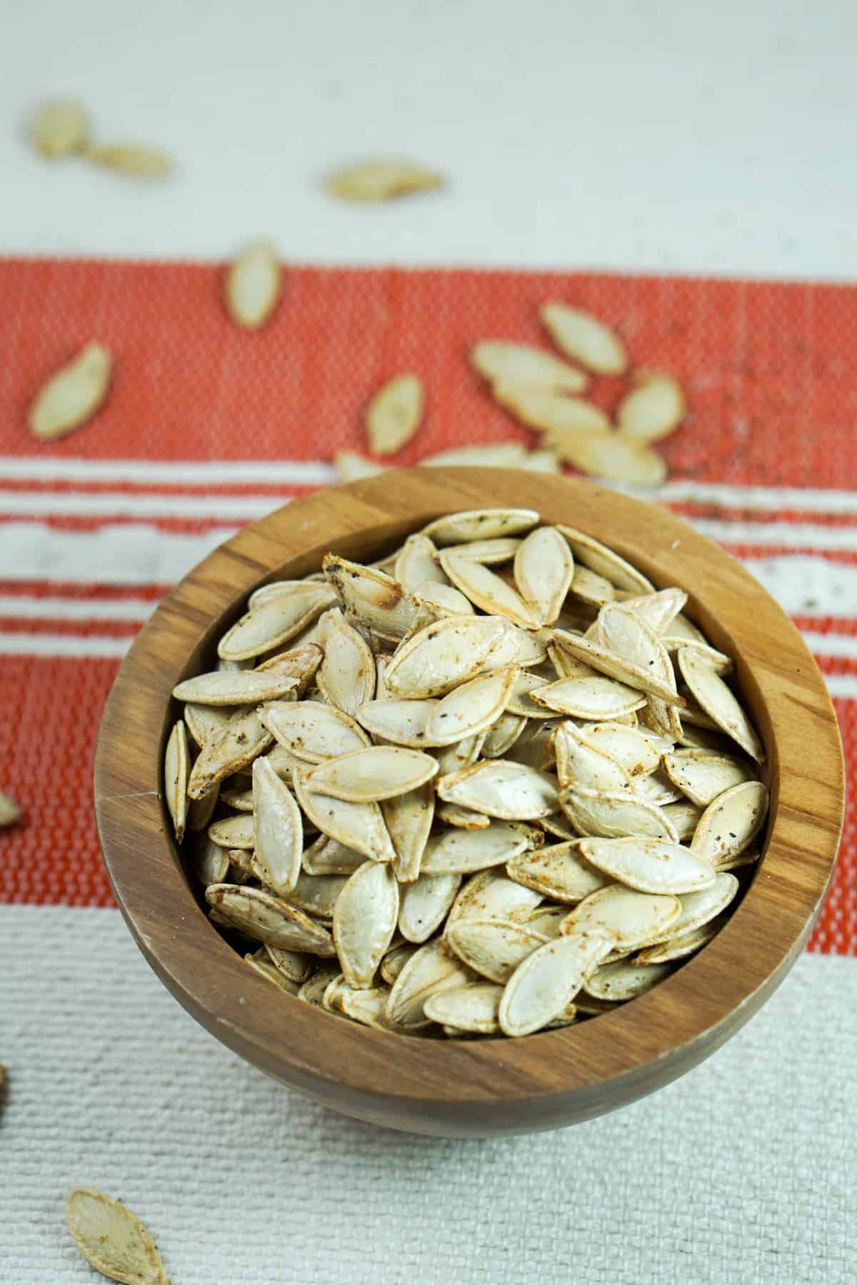 This toasted salted pumpkin seeds recipe is ridiculously easy. Wash & strain, season, dry and roast for deliciously crisp seeds. Then crunch away and enjoy!