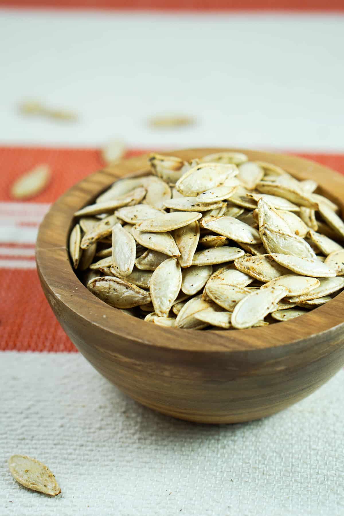 This toasted salted pumpkin seeds recipe is ridiculously easy. Wash & strain, season, dry and roast for deliciously crisp seeds. Then crunch away and enjoy!