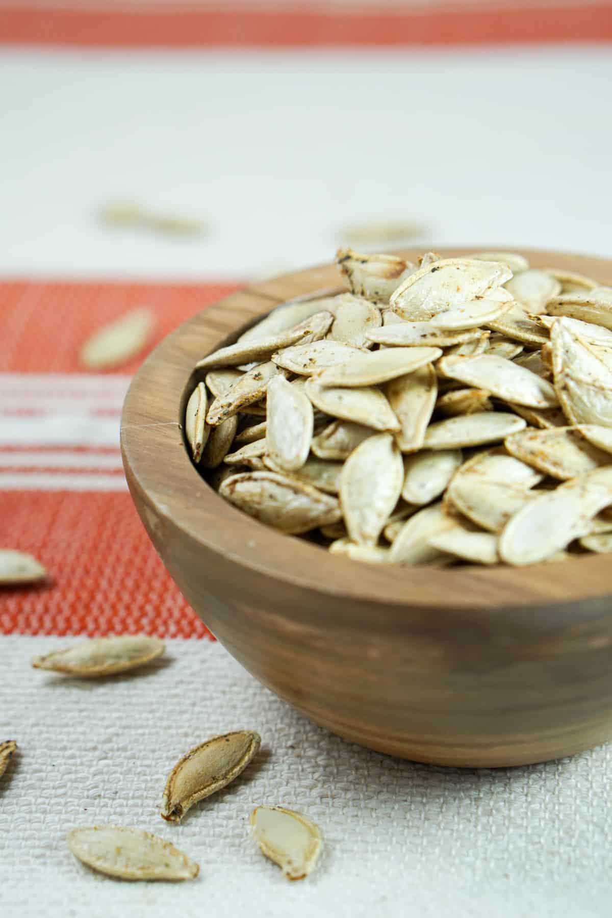 This toasted salted pumpkin seeds recipe is ridiculously easy. Wash & strain, season, dry and roast for deliciously crisp seeds. Then crunch away and enjoy!