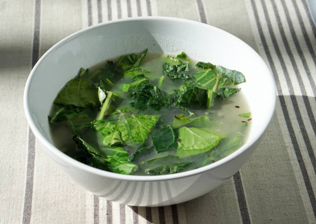 Try this nourishing bone broth over winter greens recipe is a quick and healthy meal that will reset your body after overindulging. Healthy + Delicious