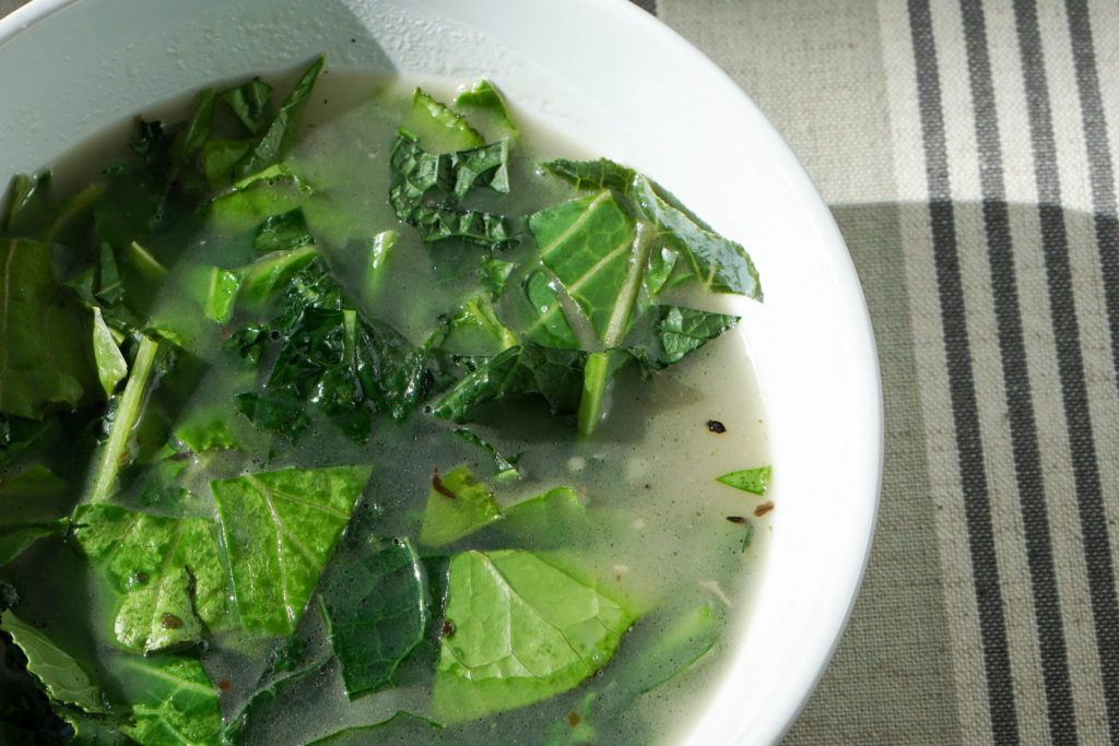 Try this nourishing bone broth over winter greens recipe is a quick and healthy meal that will reset your body after overindulging. Healthy + Delicious