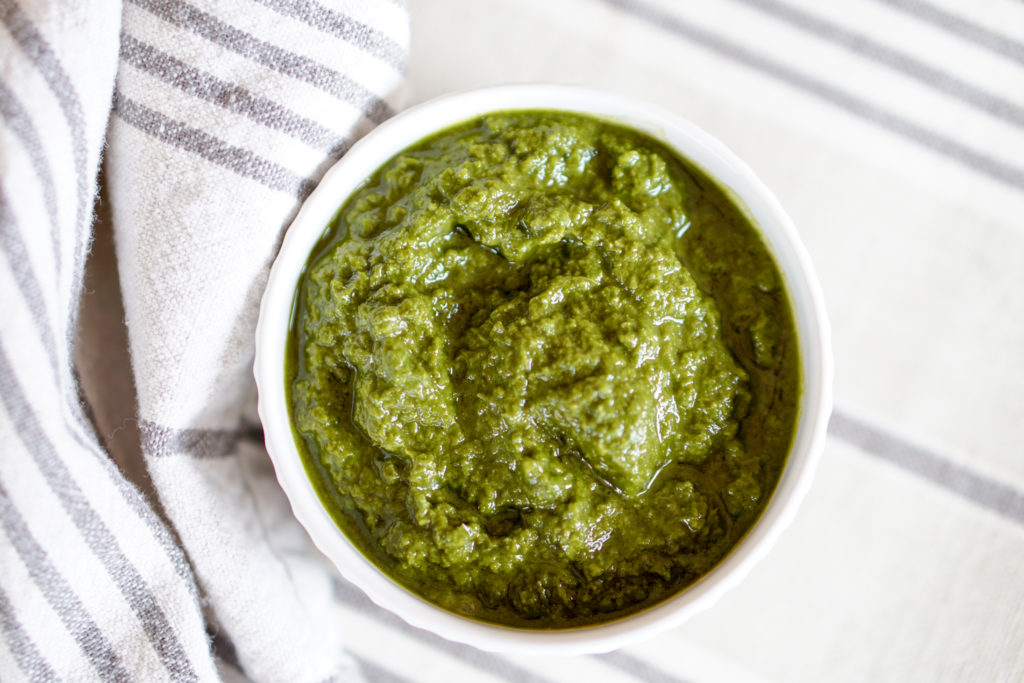 This Awesome Kale Green Sauce recipe is packed with delicious nutritious greens. 5 ingredients, 5 minutes. Use for a healthy kick on Pizza, Salads, + fries.