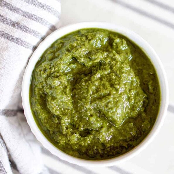 This Awesome Kale Green Sauce recipe is packed with delicious nutritious greens. 5 ingredients, 5 minutes. Use for a healthy kick on Pizza, Salads, + fries.