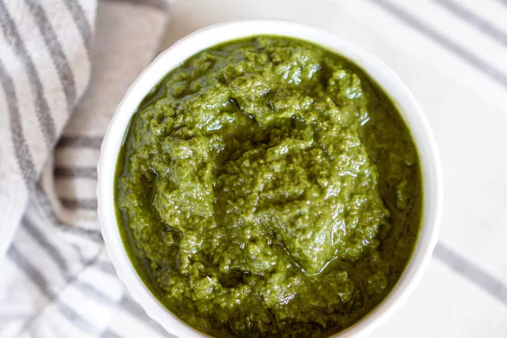 This Awesome Kale Green Sauce recipe is packed with delicious nutritious greens. 5 ingredients, 5 minutes. Use for a healthy kick on Pizza, Salads, + fries.