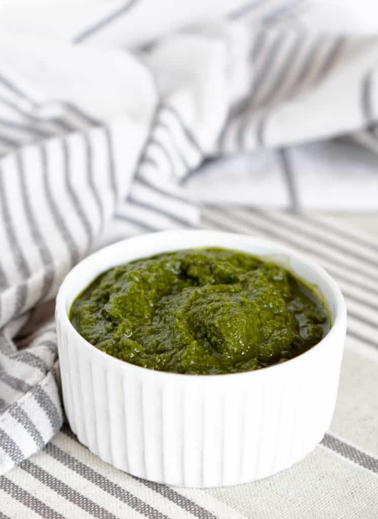 This Awesome Kale Green Sauce recipe is packed with delicious nutritious greens. 5 ingredients, 5 minutes. Use for a healthy kick on Pizza, Salads, + fries.