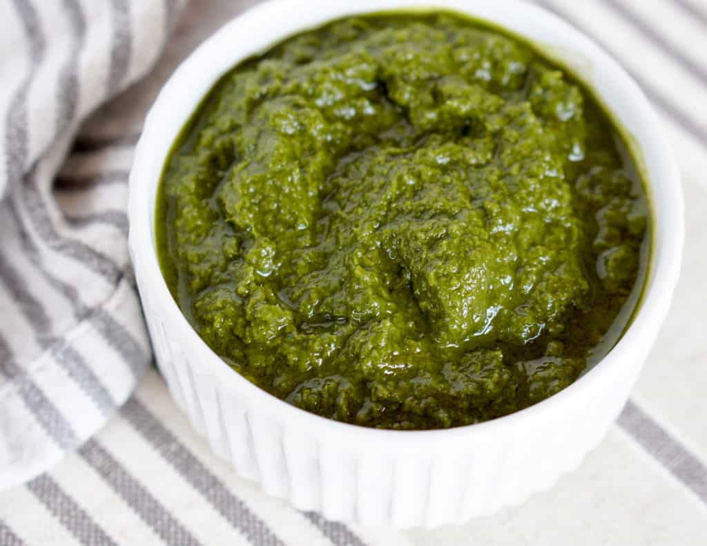 This Awesome Kale Green Sauce recipe is packed with delicious nutritious greens. 5 ingredients, 5 minutes. Use for a healthy kick on Pizza, Salads, + fries.