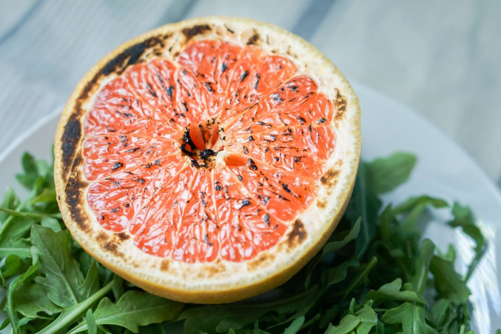 This brûléed grapefruit recipe showcases caramelized sugars without added refined sugars and cream. Add tossed arugula for a paleo, whole 30, GF, DF lunch.