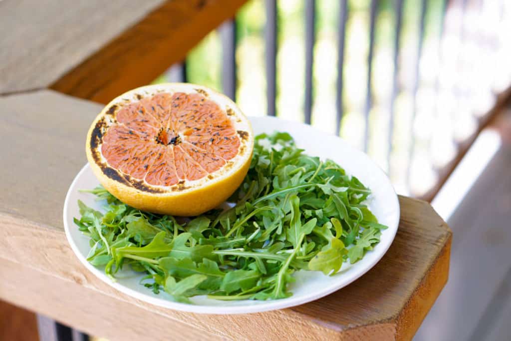 This brûléed grapefruit recipe showcases caramelized sugars without added refined sugars and cream. Add tossed arugula for a paleo, whole 30, GF, DF lunch.