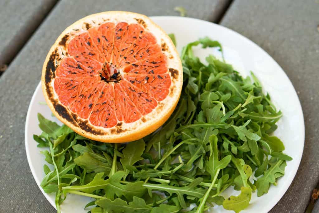 This brûléed grapefruit recipe showcases caramelized sugars without added refined sugars and cream. Add tossed arugula for a paleo, whole 30, GF, DF lunch.