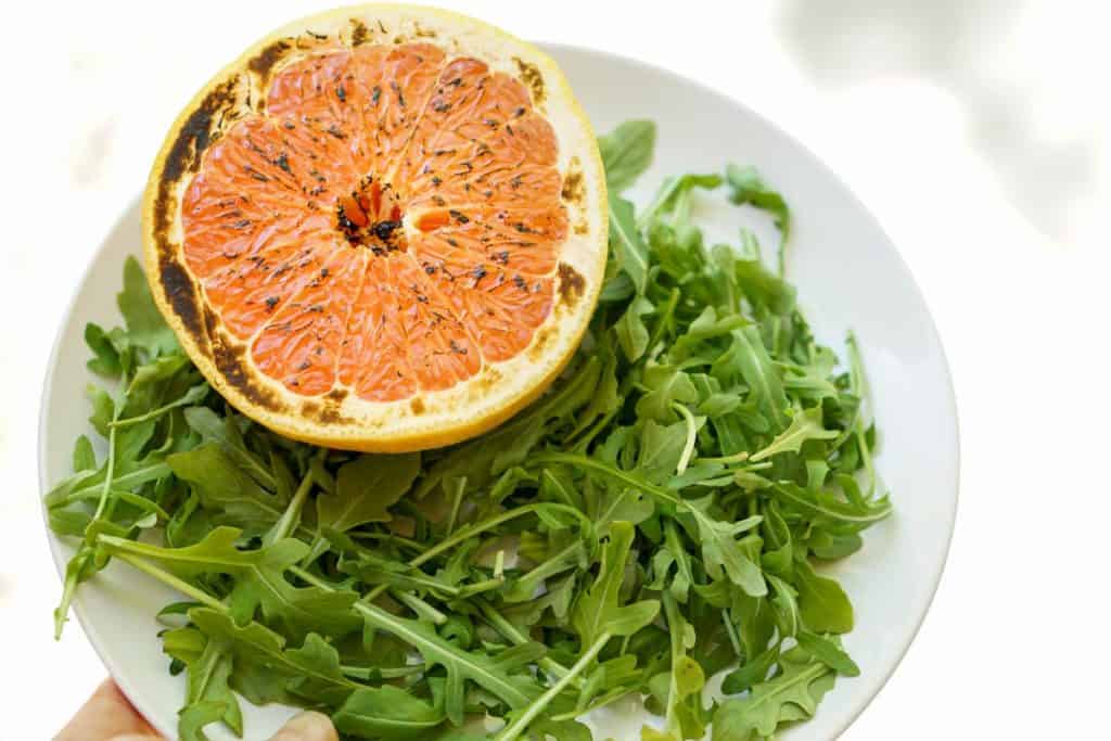 This brûléed grapefruit recipe showcases caramelized sugars without added refined sugars and cream. Add tossed arugula for a paleo, whole 30, GF, DF lunch.