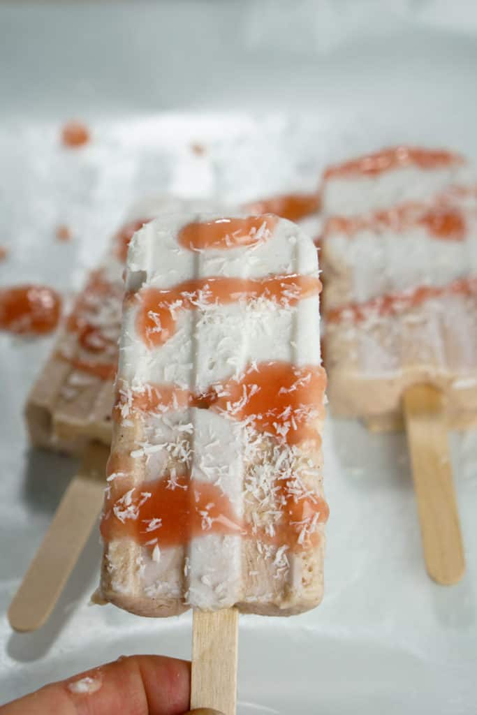 Fresh rhubarb and coconut cream are sweetened with dates and maple syrup for this refined sugar free and dairy free Paleo Rhubarb Coconut Popsicles recipe