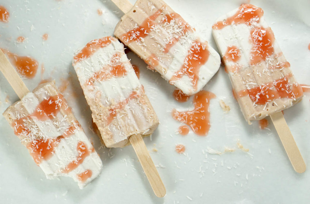 Fresh rhubarb and coconut cream are sweetened with dates and maple syrup for this refined sugar free and dairy free Paleo Rhubarb Coconut Popsicles recipe