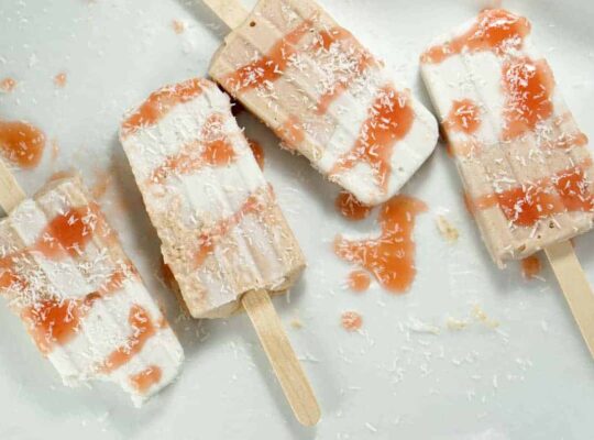 Fresh rhubarb and coconut cream are sweetened with dates and maple syrup for this refined sugar free and dairy free Paleo Rhubarb Coconut Popsicles recipe