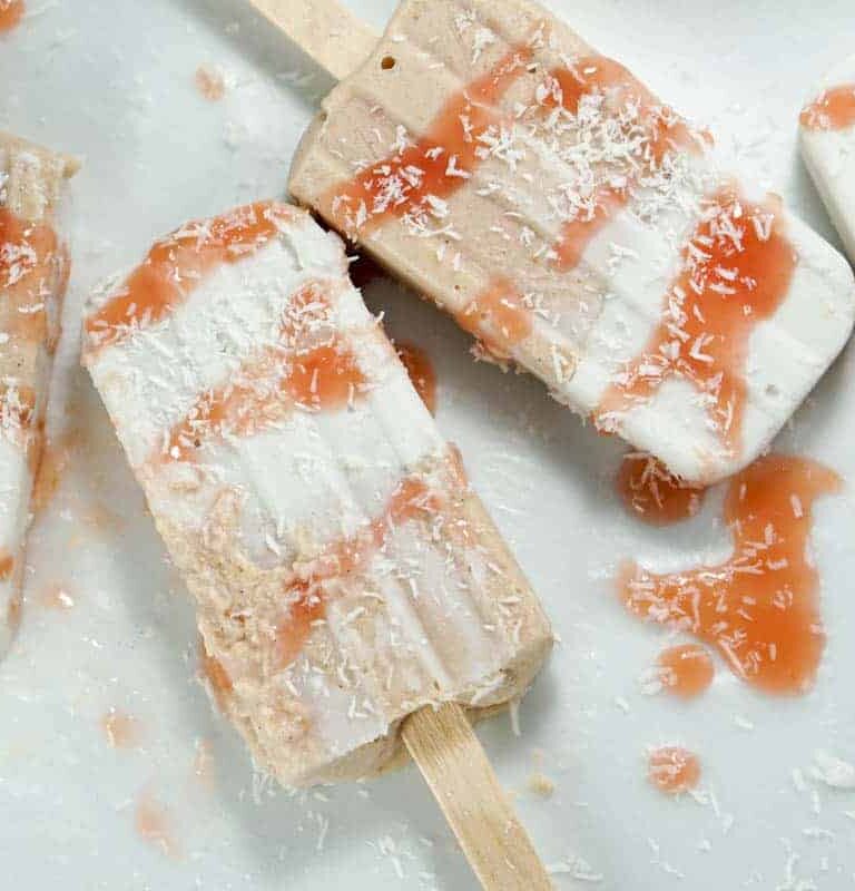 Fresh rhubarb and coconut cream are sweetened with dates and maple syrup for this refined sugar free and dairy free Paleo Rhubarb Coconut Popsicles recipe