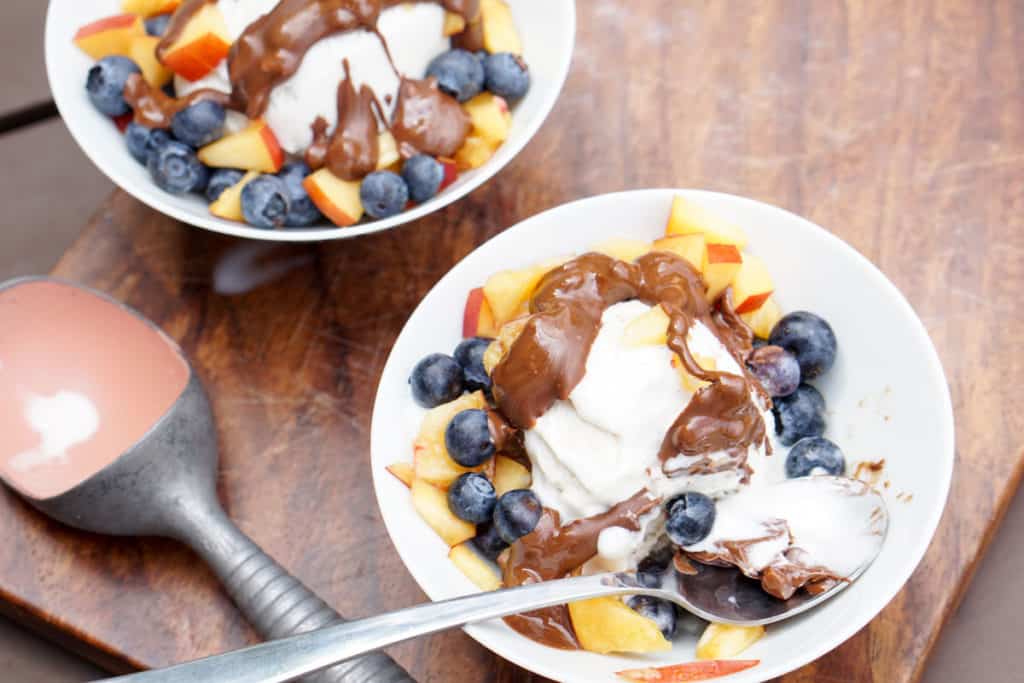 Fresh berries, creamy coconut ice cream, healthy magic shell make this great dairy free coconut berry sundae with homemade peanut butter chocolate drizzle