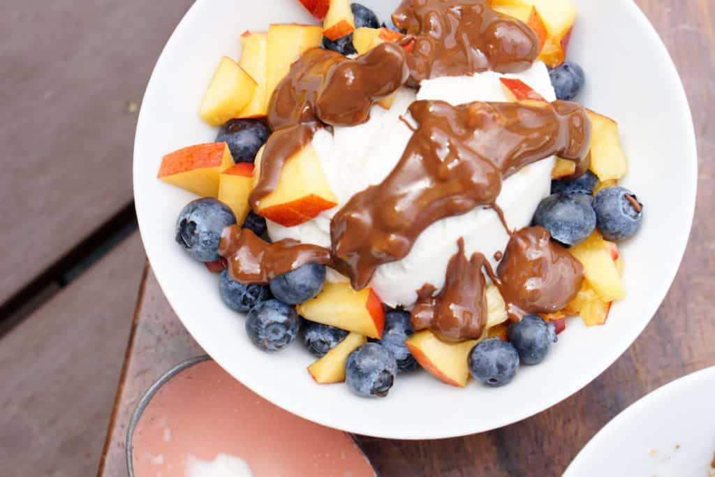 Fresh berries, creamy coconut ice cream, healthy magic shell make this great dairy free coconut berry sundae with homemade peanut butter chocolate drizzle