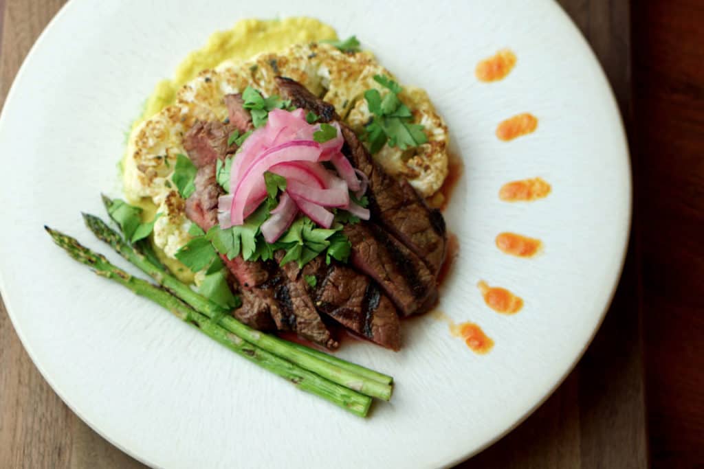 The Deconstructed Steak Taco on Curried Cauliflower Steak recipe merges the flavors of street tacos with Asian cuisine and the traditional steak house: Latin fusion that's healthy, gluten free, grain free and dairy free.