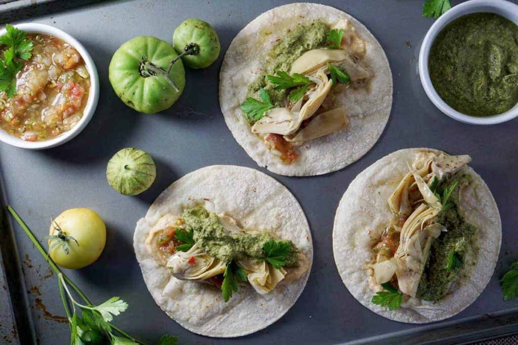 These quick vegan artichoke hummus tacos with carrot top pesto are natrually gluten, dairy, nut, refined sugar and soy free