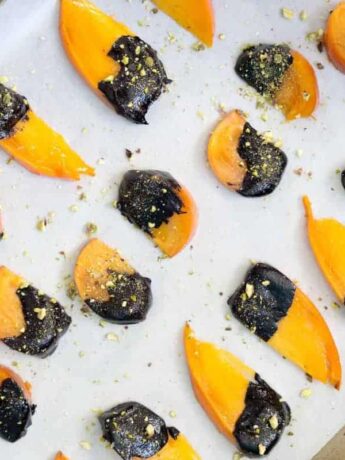 Dip ripe Hachiya or Fuyu persimmons in homemade chocolate sauce and top with crushed pistachios for the easiest dessert to impress.