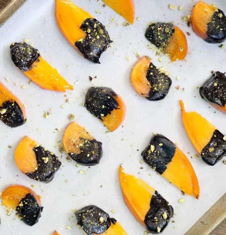 Dip ripe Hachiya or Fuyu persimmons in homemade chocolate sauce and top with crushed pistachios for the easiest dessert to impress.