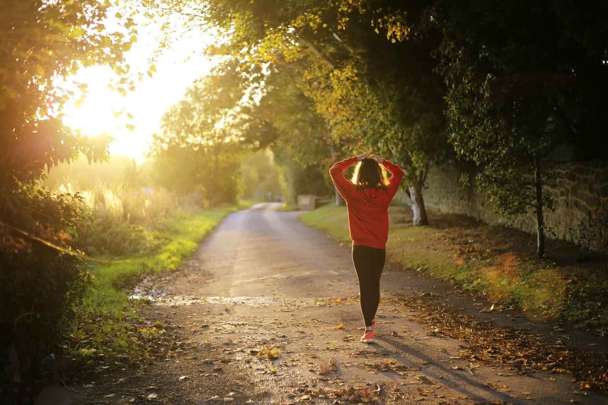 A woman walking down a countryside path