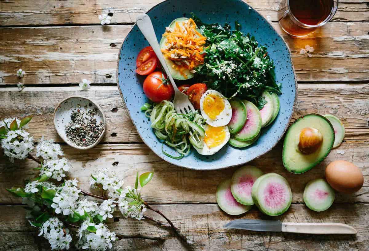 A bowl of salad with boiled eggs