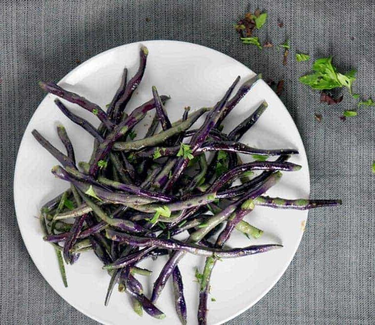 Blistered Purple Hyacinth green beans sauteed with white truffle paste create a purple and green tie-dyed plate that's the perfect savory accompaniment for any dinner.