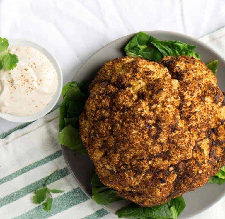 Roasted Harissa Cauliflower with Whipped Tahini makes a great side dish, dinner, and topping for salad bowls.