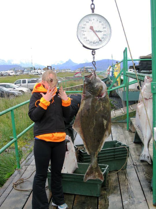 blond girl shocked at halibut catch
