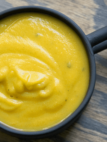 Simple blended 10 minute pumpkin soup with coconut milk and tahini in a black mug. GLuten free, dairy free, whole 30, paleo, and keto