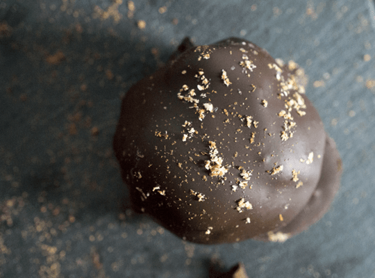 Paleo chocolate covered pumpkin pie bites are rich and creamy, densely packed with health-supporting spices and real pumpkin, stuffed with coconut butter and doused in chocolate.