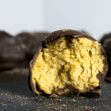 Paleo chocolate covered pumpkin pie bites are rich and creamy, densely packed with health-supporting spices and real pumpkin, stuffed with coconut butter and doused in chocolate.