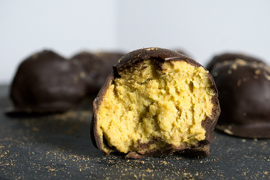 Paleo chocolate covered pumpkin pie bites are rich and creamy, densely packed with health-supporting spices and real pumpkin, stuffed with coconut butter and doused in chocolate.