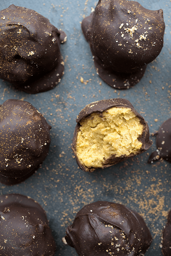 Paleo chocolate covered pumpkin pie bites are rich and creamy, densely packed with health-supporting spices and real pumpkin, stuffed with coconut butter and doused in chocolate.