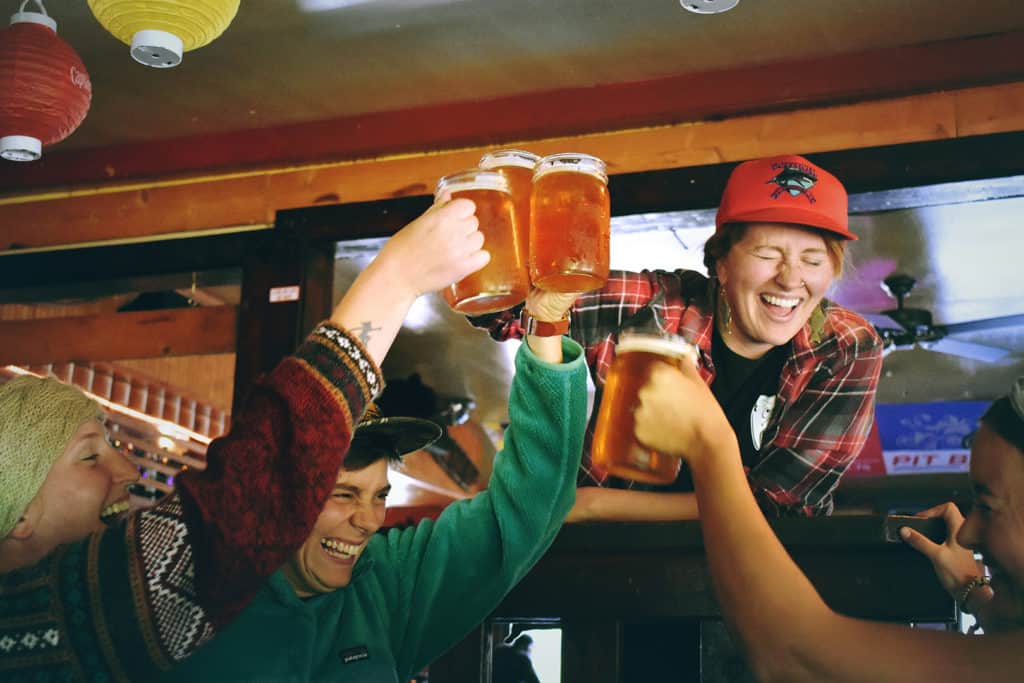 People cheersing with beers to celebrate a game winning basket