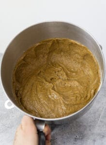Chocolate Chai Bundt Cake mixture in metal mixing bowl on cement