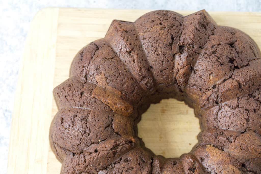 Overhead of Chocolate Chai Bundt Cake on wooden cutting board