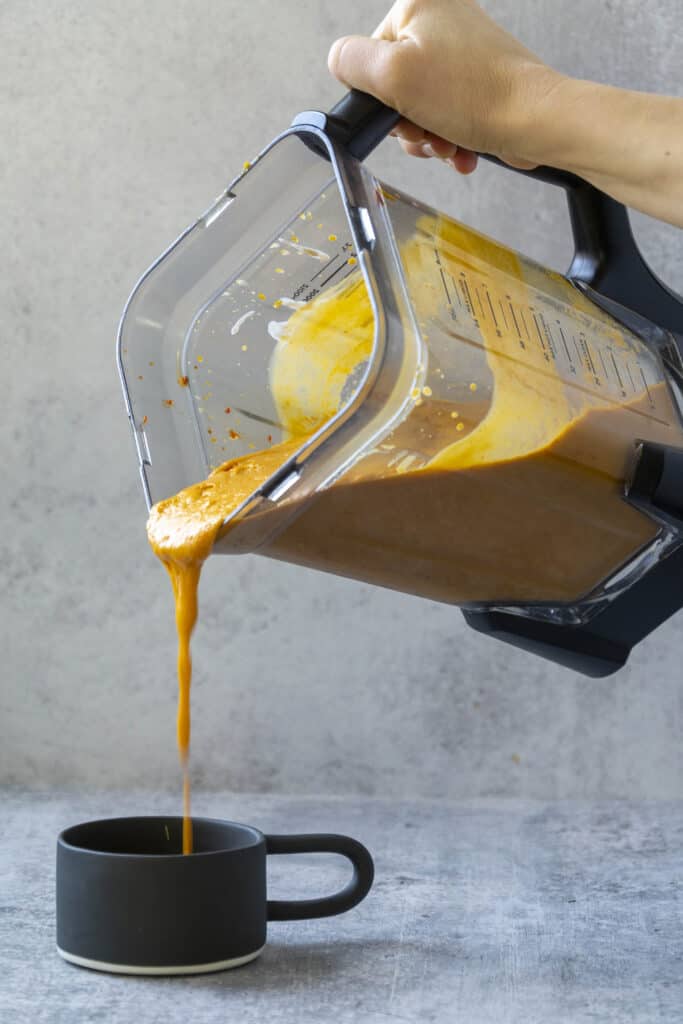 Pouring Pumpkin Thai Curry Soup from a blender