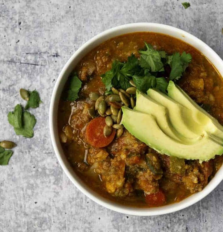 Bowl of Pumpkin Chili with Avocado and cilantro