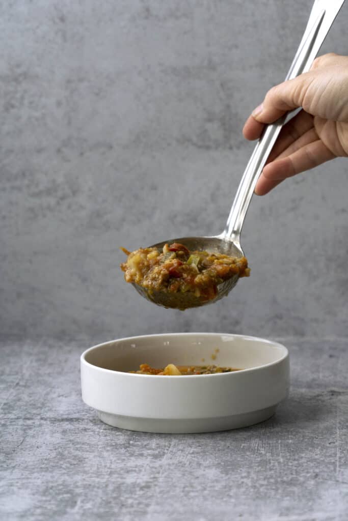 Pouring Pumpkin Chili into a bowl