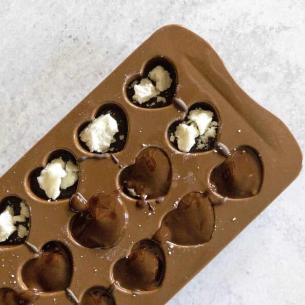 Chocolate covering Coconut Butter Balls in Chocolate Molds