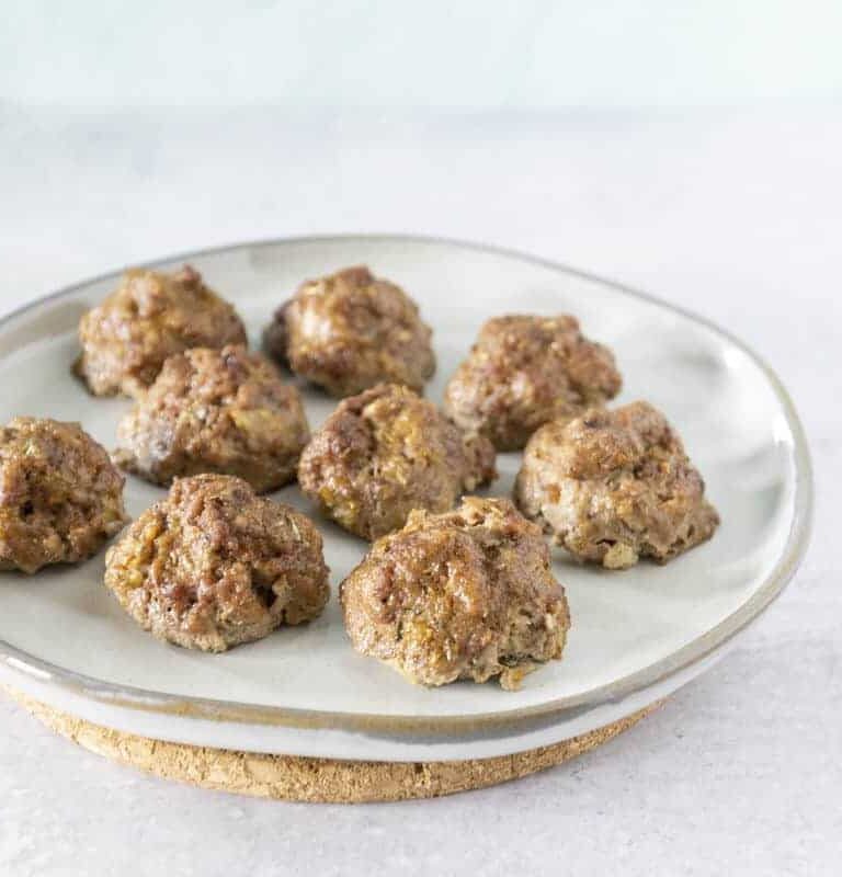 side angle of bison jicama meatballs on white plate