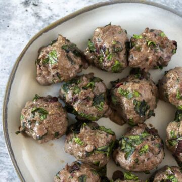 Beet Green Meatballs on white plate - close up